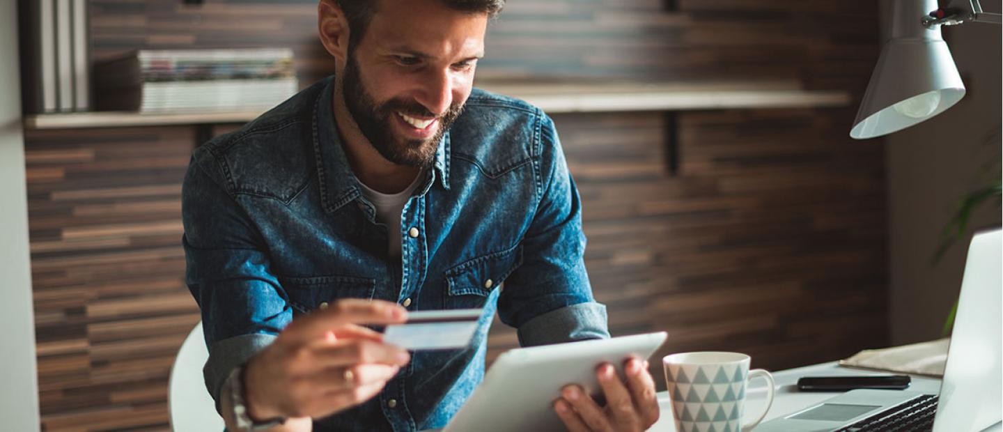 Imagen hombre con tarjeta en la mano pagado con el móvil